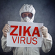 Stock photo of a man wearing some kind of pseudo-hazmat suit which wouldn’t protect him from shit, I mean, look at those thin gloves LOL (Image: Shutterstock)
